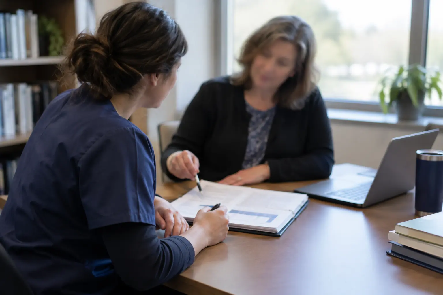 A graduate nursing student and supervisor discussing a research proposal together