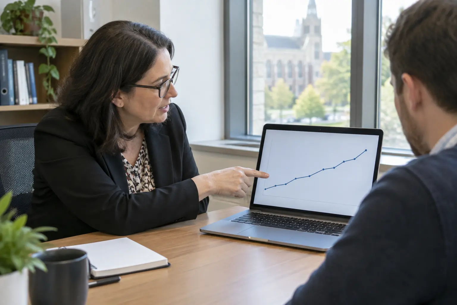 An administrator reviewing a dashboard showing improving proposal-to-defence timelines